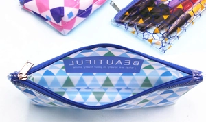 Detail of clear PVC stationery bag with blue geometric pattern and high-quality metal zipper