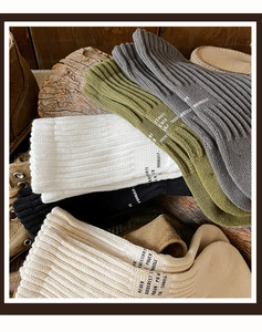 Detailed texture of thick cotton crew socks in vintage earthy tones with ribbed knit design