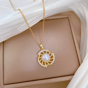 Detailed close-up of a luxury rotating pearl pendant with zircon inlay on a gold chain