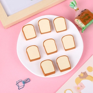 Flat lay of 8 pieces of bread toast shaped erasers on a pink background for school kids