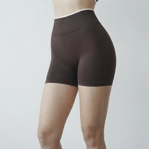 Detail of high-waisted seamless yoga shorts featuring ribbed texture and white contrast trim
