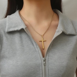 Golden double layer cross pendant necklace with twist rope chain on model