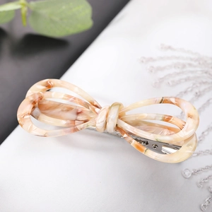 French style acetate hair clip with marble texture bow design on a white background