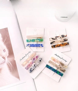 Macro shot of three tortoiseshell and marble acetate hair clips on display card