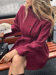 Burgundy single-breasted wool coat with stand collar and waist belt detail view