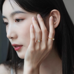 Elegant 925 sterling silver gold-plated ring with oval synthetic opal on model's hand