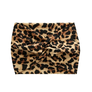 Detail of wide leopard print yoga headband featuring a stylish twisted knot design