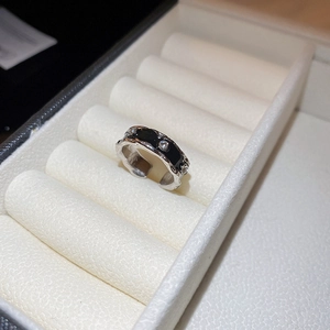 Macro detail of silver adjustable ring with black enamel and sparkling zirconia inlay
