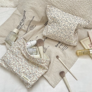 Detailed top view of large and small floral corduroy makeup bags for cosmetic storage