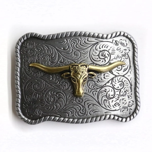 Western cowboy belt buckle with gold bull head and retro scrollwork carvings