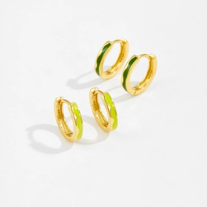 Detailed macro view of S925 sterling silver hoop earrings with enamel in green and gold