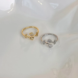 Detail of tulip rings with micro-paved diamonds in gold and silver finishes