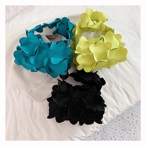 Three 3D petal-shaped small PU shoulder bags in teal, neon yellow, and black colors