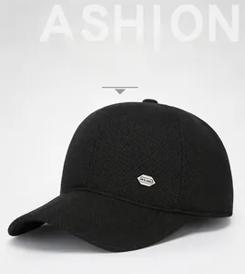 Detail view of winter baseball cap with silver metal emblem and thick ear protection fabric