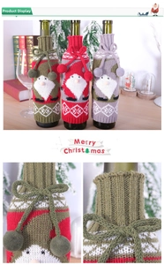 Macro shot of knitted Christmas wine bottle covers featuring Santa Claus and bow ties