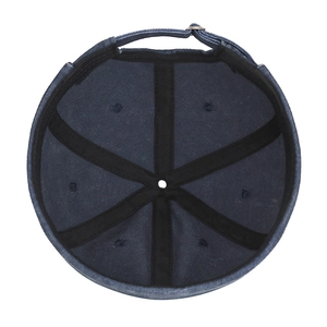Inside view of denim docker cap showing black cross reinforced seams and metal buckle