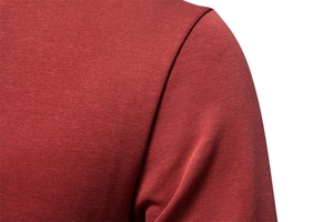 Macro detail of dark red cotton knitted fabric texture and flat shoulder seam craftsmanship