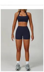 Detail of cobalt blue cross-back sports bra and high-waist shorts on model