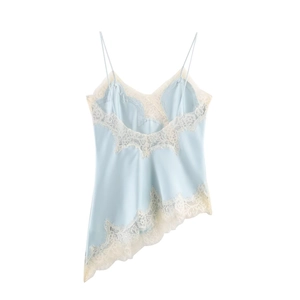 Detail of light blue satin camisole featuring cream lace trim and asymmetric hem design