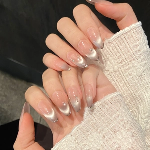Elegant long almond press-on nails with silver-grey cat eye magnetic effect and rhinestones