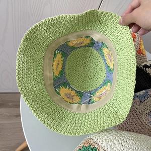 Handmade crochet straw sun hat in green with yellow sunflower pattern for summer travel