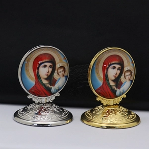 Close-up of gold and silver Orthodox religious icons with ornate floral embossed bases