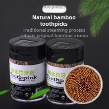 Macro detail of natural bamboo toothpicks in clear plastic bottle with black cap