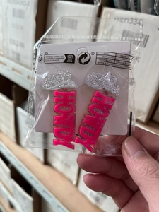 Pink glitter HOWDY letter earrings with silver cowboy hat in clear card packaging