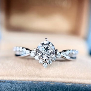 Macro shot of crown shaped diamond engagement ring with a V-shaped band on velvet