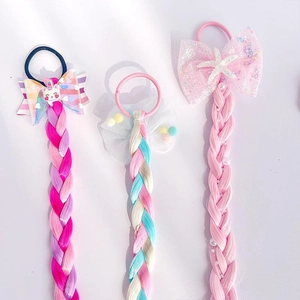 Detailed view of colorful unicorn and starfish bow braided hair extensions for girls