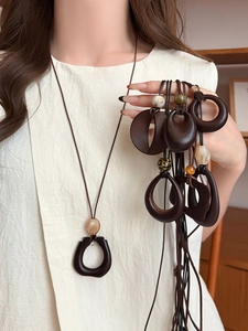 Close-up of vintage resin geometric pendant necklaces with faux wood grain texture