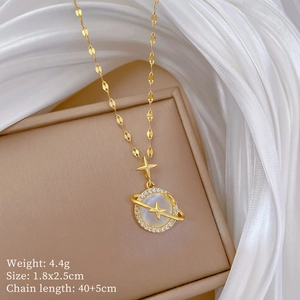 Detailed view of gold planet necklace with cat's eye stone and cross pendant