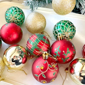 Close-up of 6cm festive Christmas ball ornaments with glitter and painted grid patterns