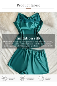 Detail of dark green satin camisole and shorts set featuring smooth texture and thin straps