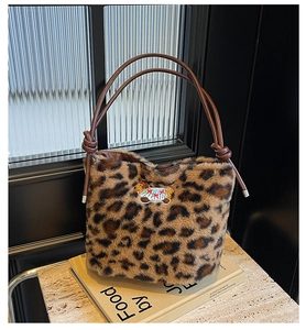 Detail of leopard print plush tote bag with cartoon lamb embroidery and leather straps