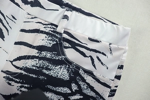 Macro shot of waistband and side pocket on black and white zebra print trousers