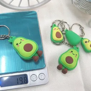 Cartoon avocado keychain in green soft rubber weighing 19.8g on a digital scale