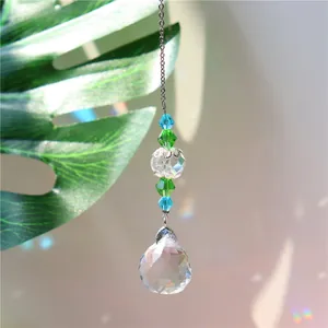 Detailed view of handmade crystal suncatcher with teardrop pendant and rainbow refraction