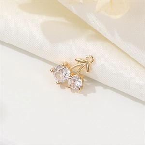 Minimalist 14k gold plated cherry pendant with sparkling cubic zirconia on white silk