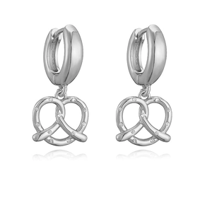 Macro detail of silver-plated pretzel knot earrings with shimmering white zircon stones