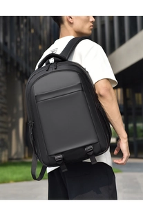Rear view of a black ergonomic business backpack on a person for urban commute