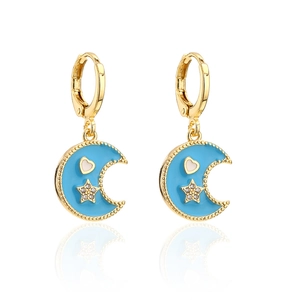 Detailed view of 18K gold plated hoop earrings with blue enamel moon and star charms
