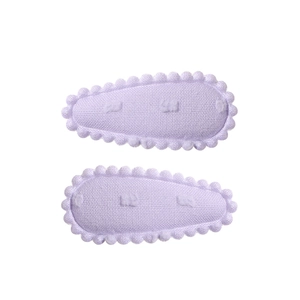 Close-up of light purple fabric drop hair clips with wavy edges and 3D polka dots texture