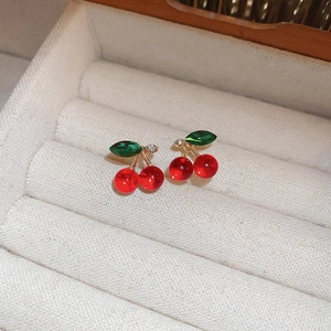 Charming red cherry stud earrings with green leaf crystals on soft velvet padding
