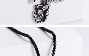 Close-up of vintage silver eagle skull and dragon claw pendant with black box chain