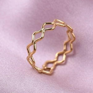 Macro shot of 18K gold plated double wave ring on premium lavender silk fabric