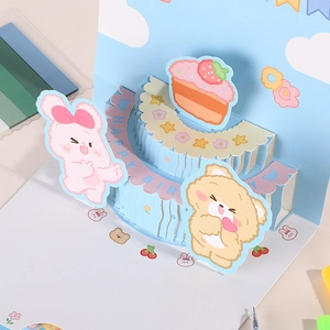 3D pop-up birthday card with cute bear, rabbit and cake in vibrant blue and pink tones