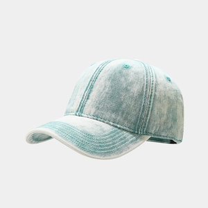 Detail shot of vintage washed denim fabric texture and stitching on a light blue baseball cap