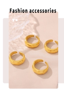 Detail shot of four 18k gold plated irregular wave rings on pink fabric and ice props