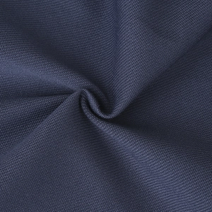Macro shot of dark blue knitted fabric texture with stars embroidery and mesh weave detail
